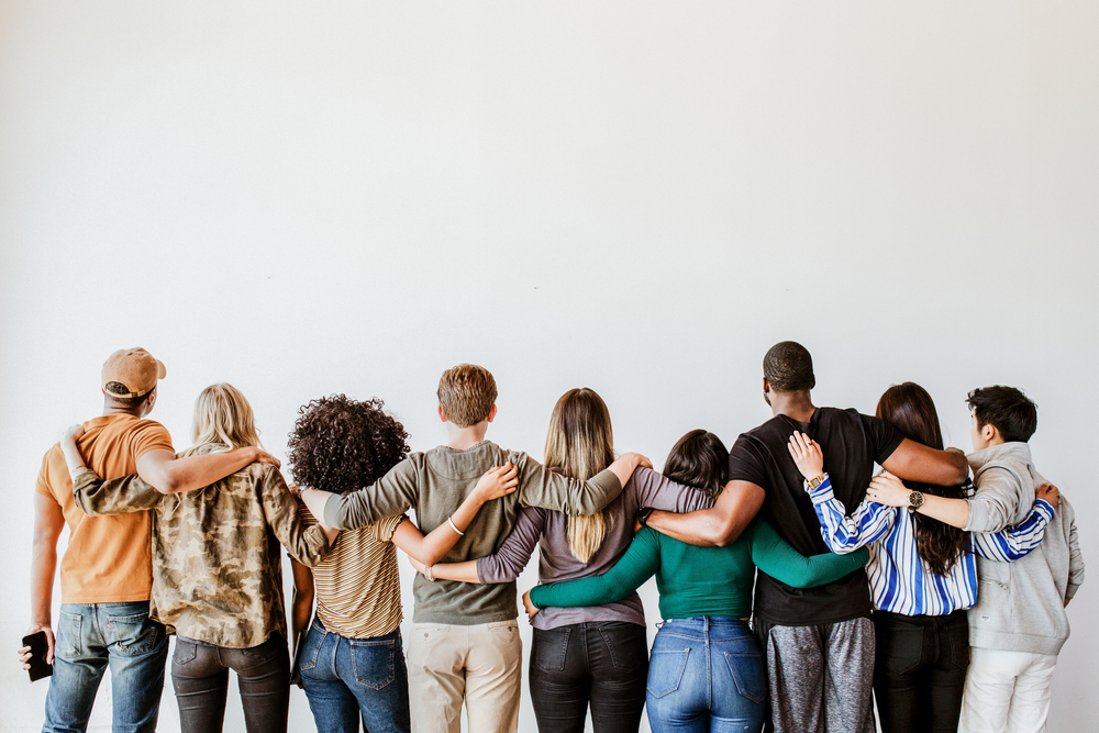 Rearview,Of,Diverse,People,Hugging,Each,Other