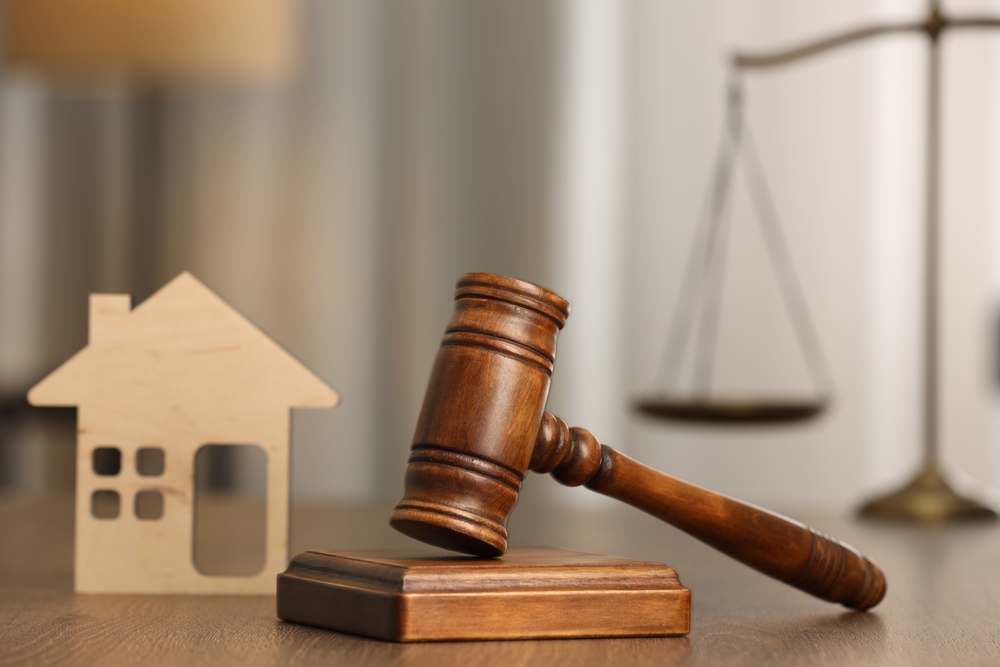 Law,Concept.,Gavel,And,Figure,Of,House,On,Wooden,Table